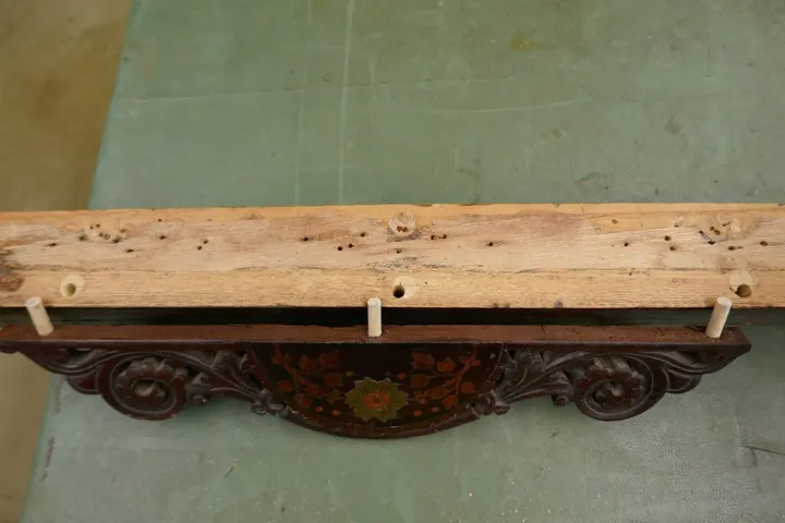 Front rail decoration had also received poorly done repairs requiring re-drilling and aligning dowels.