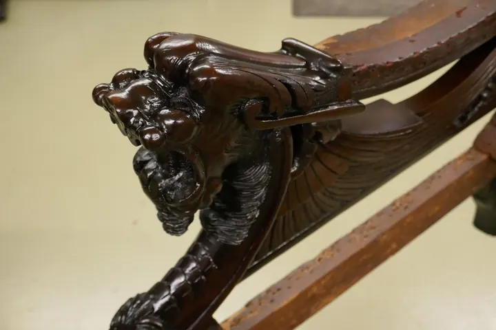 Gargoyles carved from purpleheart wood have details one must see to appreciate!