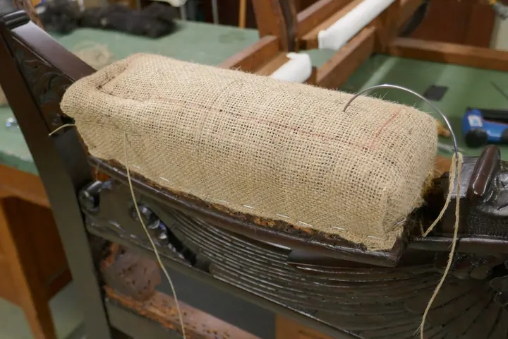 The first of two more series of stitches forms a smaller, firmer edge roll and pulls in the sides for a tapered profile.