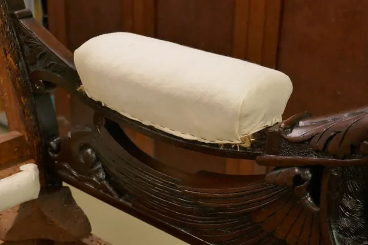 A second layer of horse hair was added before pulling the arm into a gently crowned pad. Cotton will be added before the outer cover of mohair.