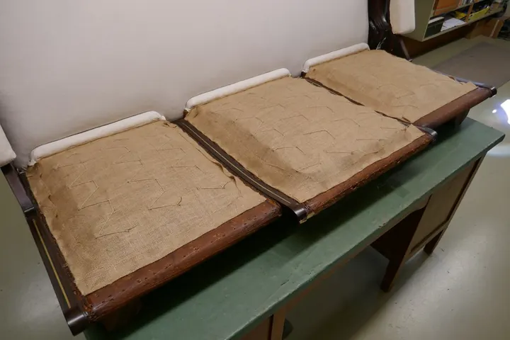 Burlap foundation stitched to springs, ready for wood wool.