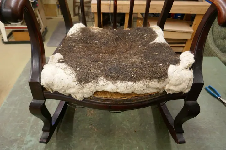 The previous upholsterer packed cotton and moss over the original stuffing materials.