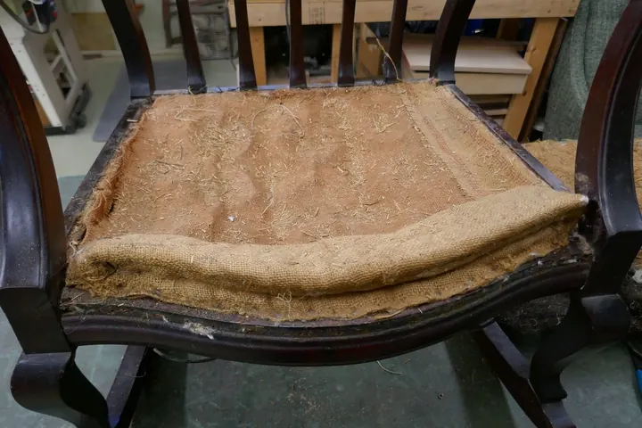 The original stitched edge was reused over the patched burlap foundation.