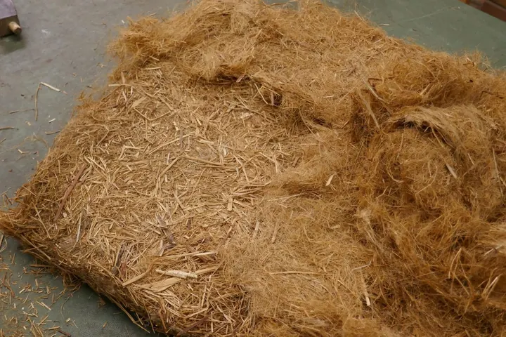 The original stuffing began with a layer of flax straw topped with a thin layer of tow fiber.