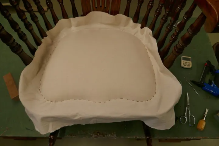 Padding pulled tightly in place with muslin.