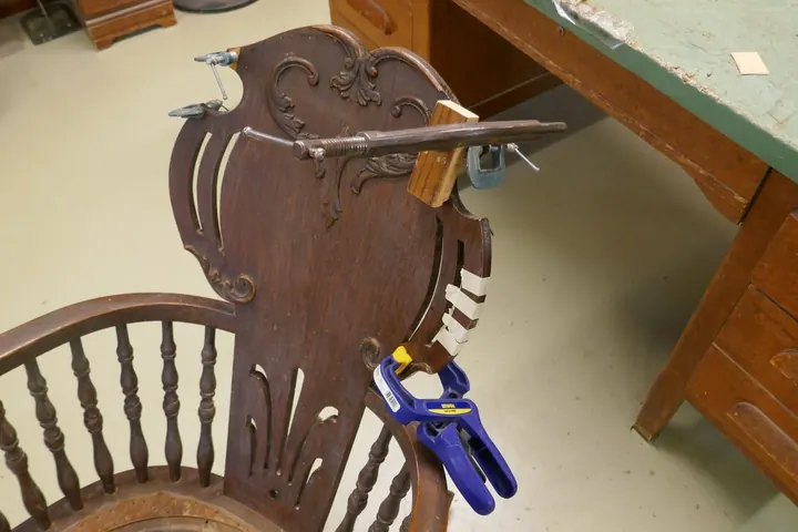 Replacing missing veneer along with re-gluing many loose areas.