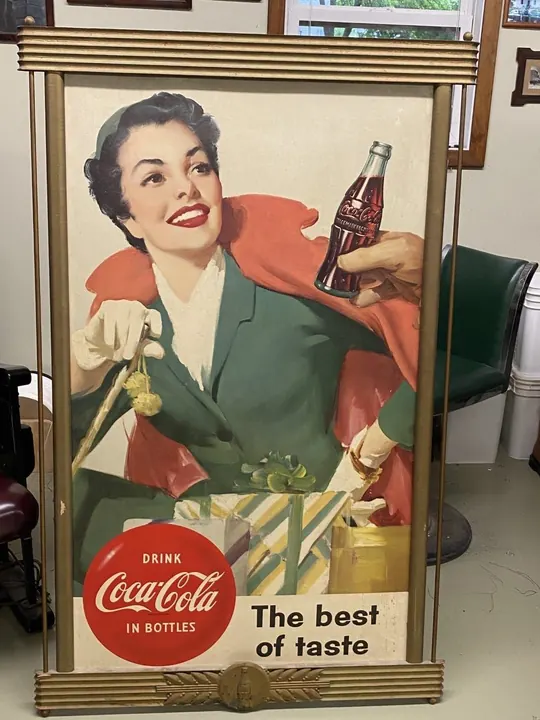 On arrival, tarnished and peeling paint, along with corrosion on the Coca-Cola medallion. Smears of grime on the poster.