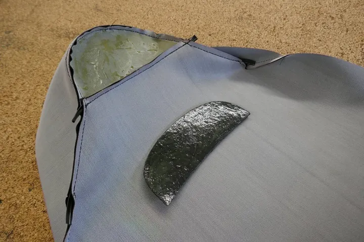 Completed cover with hard rubber tail support being glued in place.