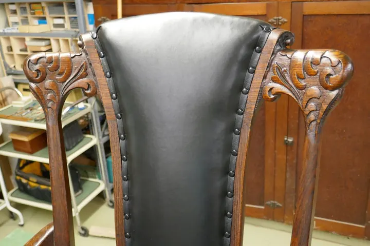 Two layers of cotton batting pulled down with leather and nail trim.