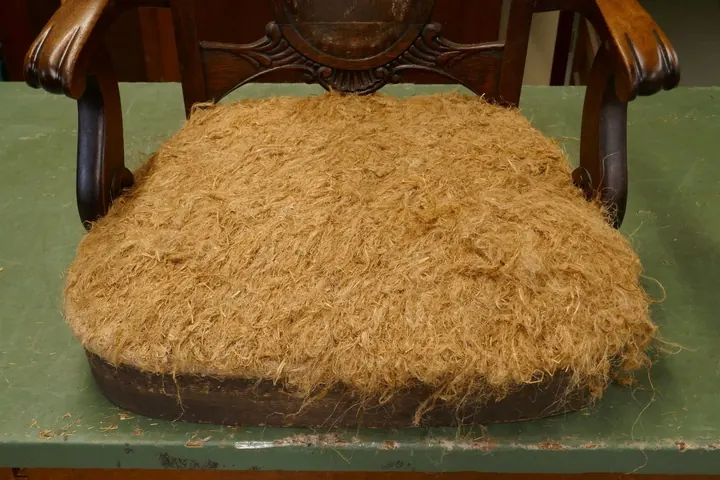 1 1/2" thickness of recycled tow fiber, over 100 years old.