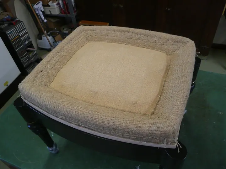 Starting at the bottom and working up, four rows of stitching pulls the wood wool into a very firm profile.