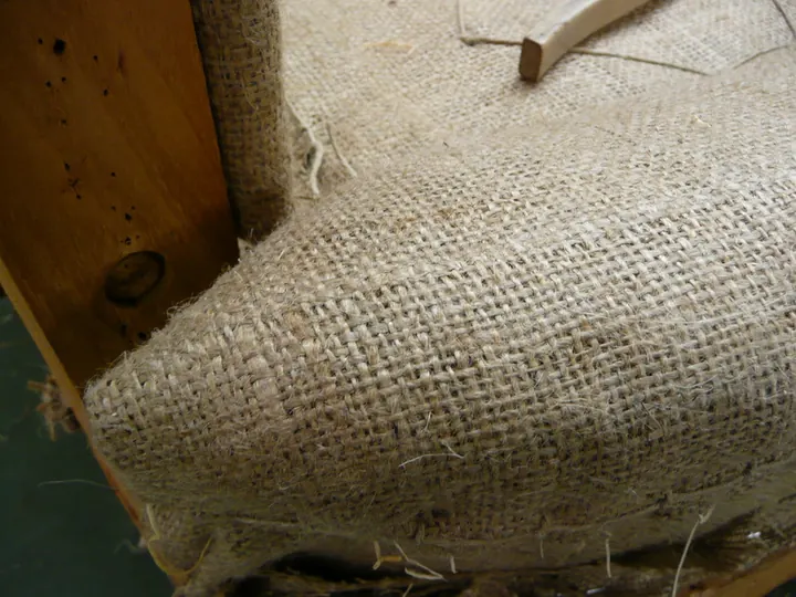 Burlap and first stuffing, on a 1920s parlor chair in the shop
