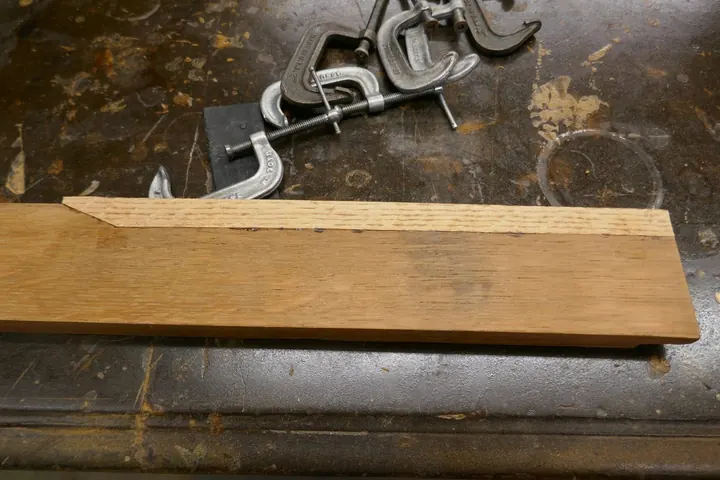 Top surface had an area of serious water damage leaving stains, loose and missing veneer. I cut away the damage and replaced it with a double layer of veneer in order to get adequate thickness.