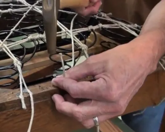 Kim Buckminster tying coil springs by hand